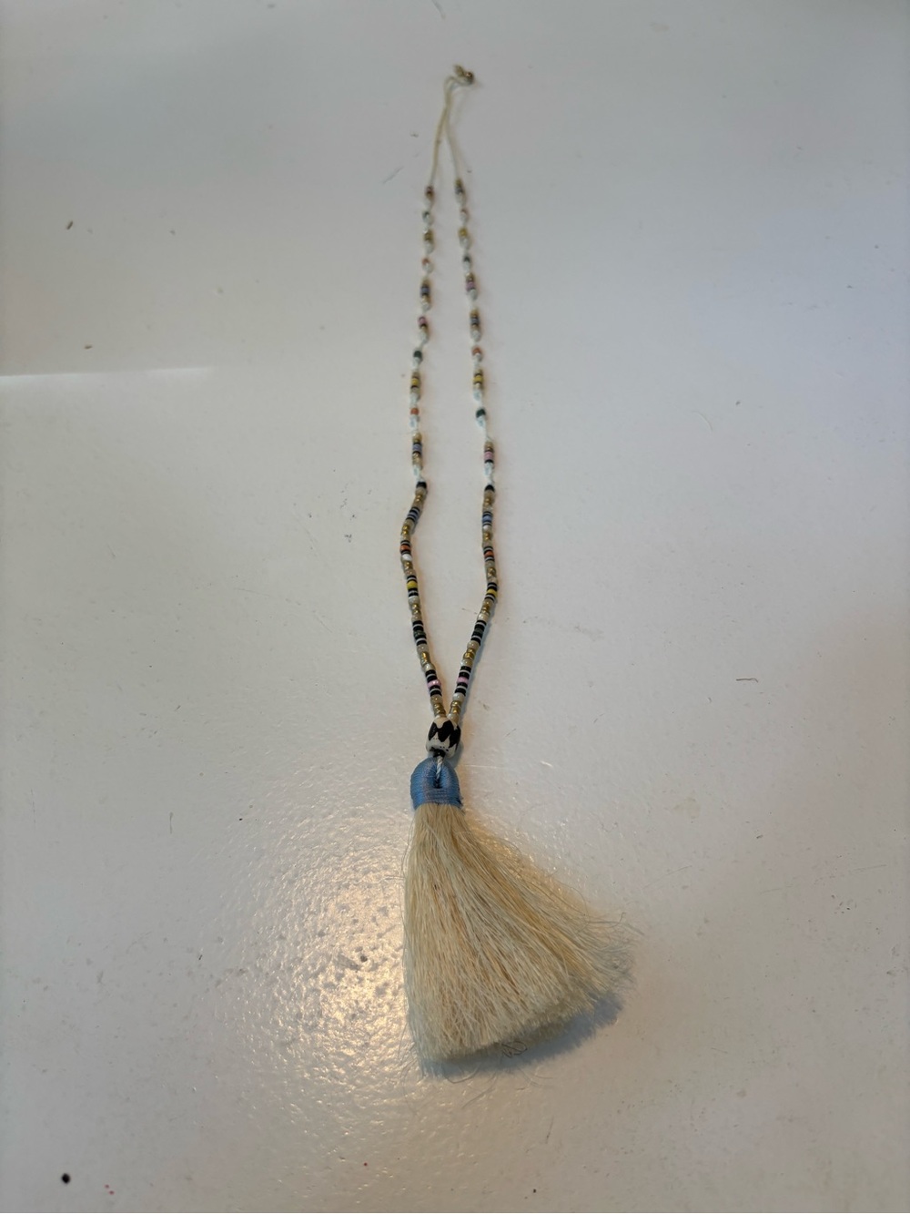 Noonday Collection Cream Tassel Necklace with Light Blue Accent